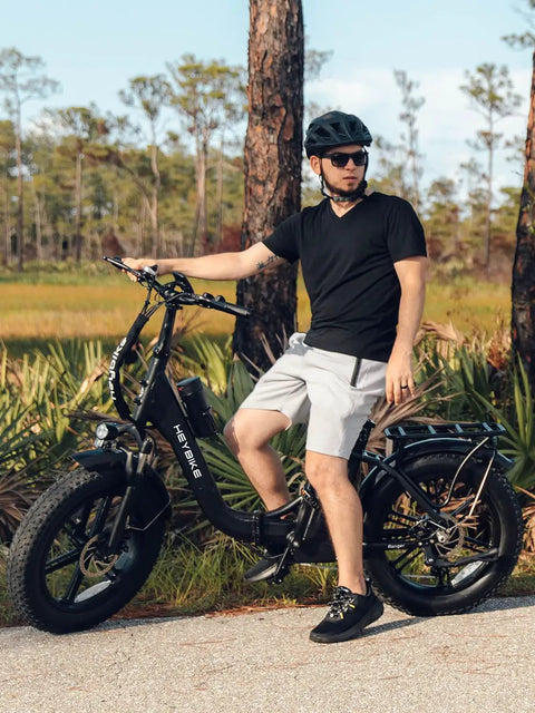 Man riding Ranger Two Point Zero Fat Tire Electric Bike For Adults with 1400W Peak Power and 20 Inch Step Through Frame in park