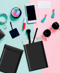 Black Bubble Mailers 4x8 Inches Self-Sealing Padded Envelopes, 200 Pack next to accessories, showcasing usage for small items.