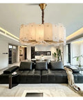 Slick Modern Marble Ceiling Pendant Light With Easy Dimmable Brightness And Genuine Stone Build That Totally Boosts Your Dining Room Or Kitchen Island Home Lighting Setup above modern black sofa in a stylish living room.