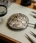 Drop In Hand Winding Mechanical Watch Movement ST3621 ETA6498 Replacement Part on workbench with magnifying glass