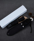 Straight Outdoor Survival Knife With Leg Straps And Sheath, lightweight blade next to packaging, on dark background