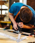 Man using power tool on wood with Straight Up Best Two Piece Clear Plastic Goniometer Set for measuring angles.