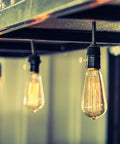 4-pack brass metal lamp switch knobs for standard light sockets on a hanging Edison bulb fixture.