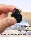 Close-up of black rubber trailer hub cap dust plug, 1.98-inch diameter, held in hand