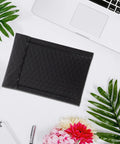Black Bubble Mailers 12 By 18 Inch Plus 4 Inch Padded Self Seal Shipping Bags shown on desk with notebook and coffee
