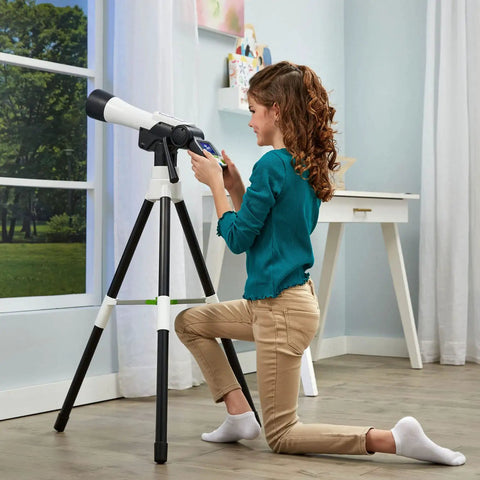 Totally Kid Friendly Space Explorer Telescope With Two Point Four Inch Video Screen And 110x Zoom Moon Viewing And Adventure Game Digital Telescope For Learning And Outdoor Stargazing on tripod with child indoors