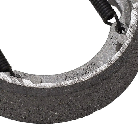 Close-up of electric scooter front drum brake pad shoe replacement part built tough from lightweight metal for smooth stops.