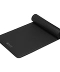 Killer 10mm Thick Yoga Mat With Big Time Cushioning Plush NBR Foam Joint Relief For Beginners Pilates Stretching Floor Workouts Includes Cinch Strap Black rolled yoga mat on gym floor.