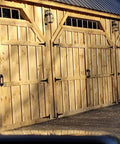 Wooden barn doors with installed 8 Inch T Strap Barn Door Hinges Heavy Duty Gate Hinge Set Black Wrought Iron Rustproof 6 Pcs