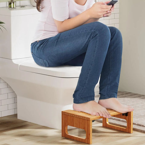 Woman using 7 Inch Bamboo Toilet Stool For Adults, Foldable Squat Potty Stool For Bathroom, 0.79 Inch Thick With Non Slip Strip by toilet