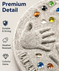 Close-up of DIY Handprint Stepping Stone Kit For Garden Easy No Mess Large 14 Inch Cement Footprint Stone with colorful gems.