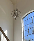 Open Globe Chandelier 21 Inch 4-Light Modern Sphere Orb Pendant In Brushed Nickel Finish hanging in an entryway with window view