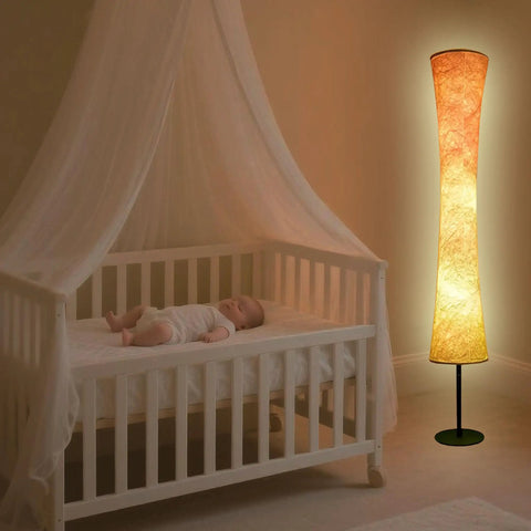 Smart Floor Lamp With RGB LED Color Changing Lights App Control DIY Mode Music Sync Alexa And Google Assistant Compatible Standing Lamp With White Fabric Shade For Living Room Bedroom And Play Room next to a baby crib.