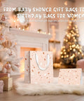 All In One Gift Bag Set With Four Medium 9 Inch Bags and festive decor by a Christmas tree for baby showers and birthdays