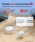 No Sweat Photoelectric Smoke Detector, Battery Powered Fire Alarm For Home Safety, UL Certified, compact and tapered design on a desktop.