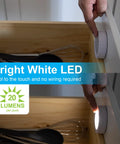 Person activating Under Cabinet LED Puck Lights Wireless Battery Operated Touch Activated Stick On Lighting For Kitchen