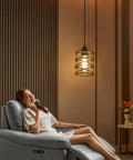 Woman relaxing under Two Pack Black Spiral Cage Pendant Lights With Clear Glass Shade And Frosted Inner Glass