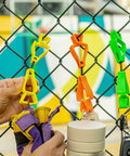 Yellow Glove Clips For Work Glove Holders 6 Pack Pro-Grade POM securing gloves on a fence, ideal for tough worksites.