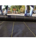 Heavy-Duty Weed Barrier Fabric 4 By 100 Feet Breathable Woven Polypropylene Ground Cover being installed outdoors
