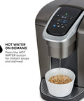 Kick Up Your Morning Routine With This Dope Single Serve Coffee Maker Featuring K Cup Compatibility Strong Brew And Iced Settings Programmable Temp Control Plus Multiple Cup Sizes In Solid Brushed Slate pouring hot water into a bowl of oats