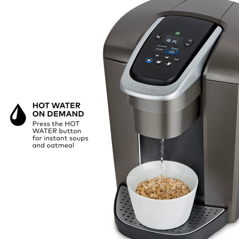 Kick Up Your Morning Routine With This Dope Single Serve Coffee Maker Featuring K Cup Compatibility Strong Brew And Iced Settings Programmable Temp Control Plus Multiple Cup Sizes In Solid Brushed Slate pouring hot water into a bowl of oats