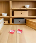 Peel And Stick Clear Acrylic Cabinet Hinges 80 Pack No Drill Install in a wooden shelving unit with various boxes.