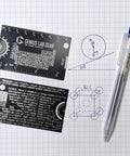 Mini 3 Inch Metal Science Ruler And Multitool With Metric And Imperial Scales Protractor And Compass on graph paper