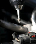 Pro Grabit 8430P Two Step Drill Bit And Screw Extractor Kit attached to a drill in automotive repair setting