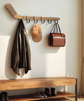Top Shelf Hockey Stick Coat Rack Featuring Six Rock Solid Hooks Ideal For Dropping Your Jackets Hats And Gear Quick Wall Mounted Storage Piece That Saves Floor Space And Keeps Your Entryway Clean with a brown leather coat and bag.