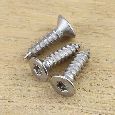 Number 6 X 3/4 Inch Flat Head Torx T15 Self Tapping Screws For Wood And Sheet Metal on wooden surface.