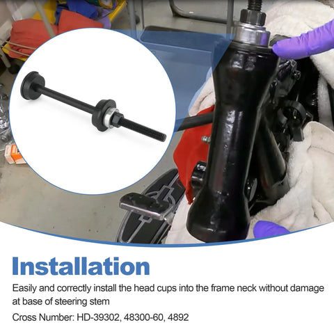 Steering head cup installer tool, black metal with threaded rod and spacers, installed on a motorcycle front fork.