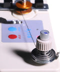 Portable Automatic Bobbin Winder for Sewing Machines on white base, close-up of spool pin and guide rod