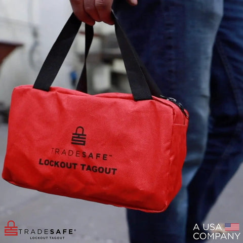Heavy Duty Lockout Tagout Bag for LOTO Devices, red tear-resistant canvas, held by person, with strong handles, outdoor view.
