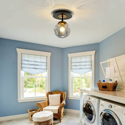 Sleek 1 Light Mini Glass Globe Ceiling Light in Black Finish Semi Flush Mount in laundry room with blue walls and wicker chair