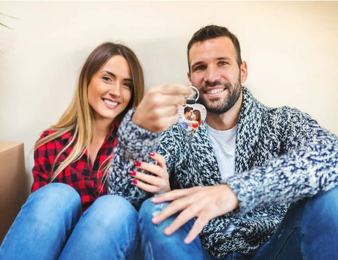Couple holding a sublimation keychain blanks set PU leather heat transfer key ring with customized photo design.