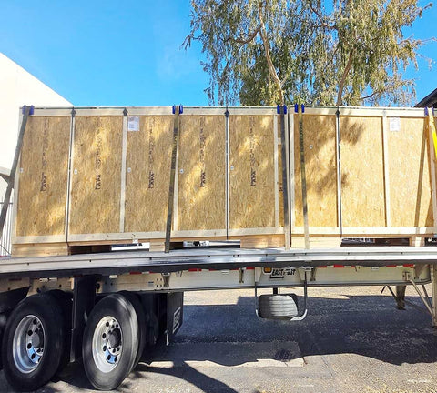 Wooden crates secured on flatbed truck using 20 Pack 4 Inch Edge Protectors For Flatbed Trucks With Mesh Carrying Case