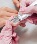 Hands using Cordless Electric Nail File Drill With Rugged 2000 Mah Battery And Bright Led Lamp for nail refinements.