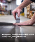 Applying Heavy Duty Duct Tape DT11 Silver 48 mm x 54.8 m (11 mil) on industrial surface, showcasing strength and adhesive grip