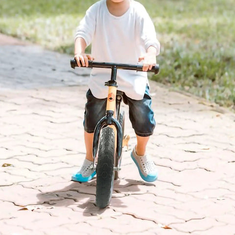 Child riding a bike with 11 Inch Balance Bike Replacement Wheel Set Non Inflatable EVA Foam For Strider And Other 11 Inch Bikes Easy Install Durable Safety Wheel Black 1 Pair Guaranteed.