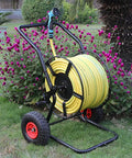 Totally Rock Solid Heavy Duty Garden Hose Reel Cart With Smooth Rolling Wheels Low Center Base Stays Put Outdoors, with yellow hose.