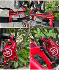 Heavy Duty Hydraulic Disc Brake Set Front And Rear With Two Piston Aluminum Calipers Long Brake Lines For Mountain Road Bicycles Sick Stopping Power Dope Red Finish on bike handlebars and calipers.