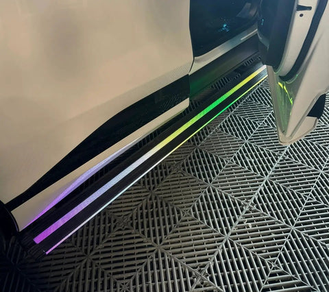 Slick Electric Deployable Running Boards For Tesla Cybertruck, illuminated side steps showing smooth design and automatic functionality.