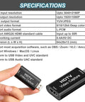 Hand holding HDTV Video Capture device with specifications chart detailing input resolution, formats, and dimensions.