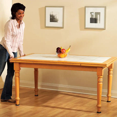 Person easily moving a wooden table on hardwood floor with 20 Piece Assorted Felt Furniture Sliders Set For Hard Surfaces