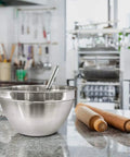 V Shaped 5 Qt Stainless Steel Mixing Bowl With Polished Finish on kitchen counter, perfect for baking and mixing sauces.