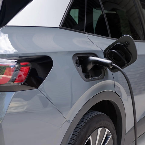 48 Amp Level 2 Wall Mounted Indoor Outdoor Fast Electric Vehicle Charging Station With 25Ft Flexible Cable Nema 14-50 Connector charging a vehicle.