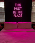 This Must Be The Place Neon Sign Dimmable Light Decor for Bedroom with hot pink glow over bed creating cozy vibe