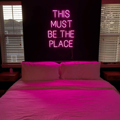 This Must Be The Place Neon Sign Dimmable Light Decor for Bedroom with hot pink glow over bed creating cozy vibe
