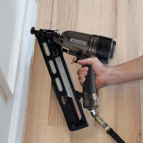 User operating Pro Grade 15 Gauge Finish Nailer Pneumatic With 34 Degree Angled Drive on wooden flooring