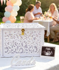 Slick White Silhouette Wedding Card Box With Lock And Slot, floral envelope holder at outdoor reception table.